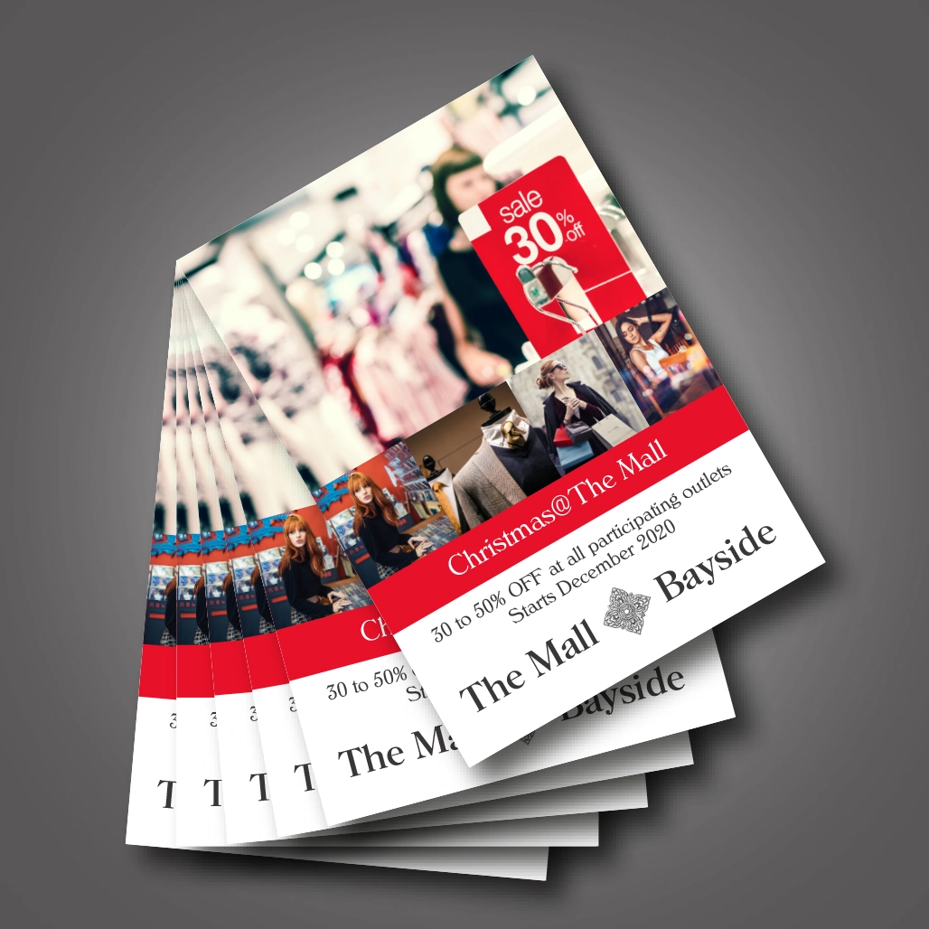 A stack of flyers for 'The Mall Bayside' that advertises discounts for Christmas shopping