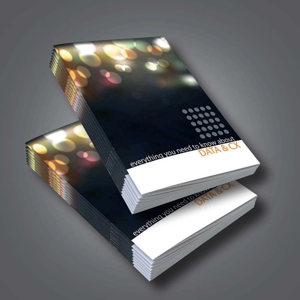 An A5 saddle stitched book with a black self cover that features a thick white band at the bottom 