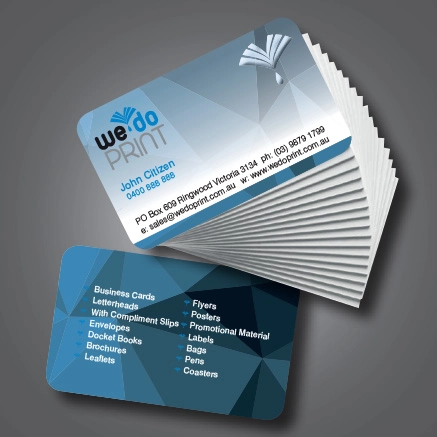 Stack of blue and white business cards with round corners displaying information about We Do Print